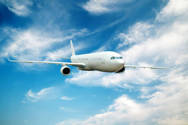 Large passenger plane flying in the blue sky