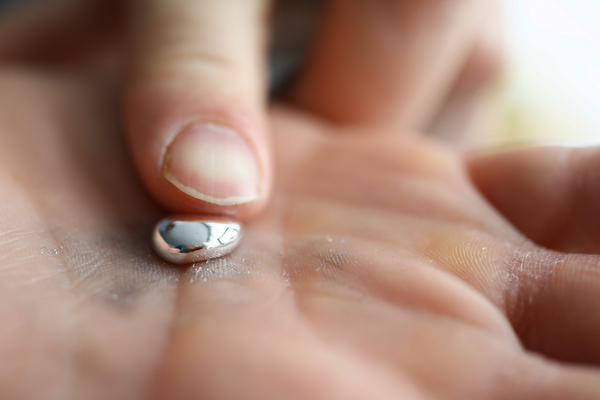 hand holding gallium in a liquid form