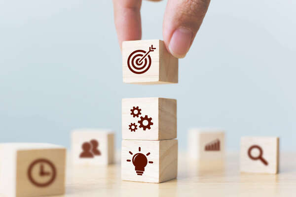 hand putting wood cube block on top with icon